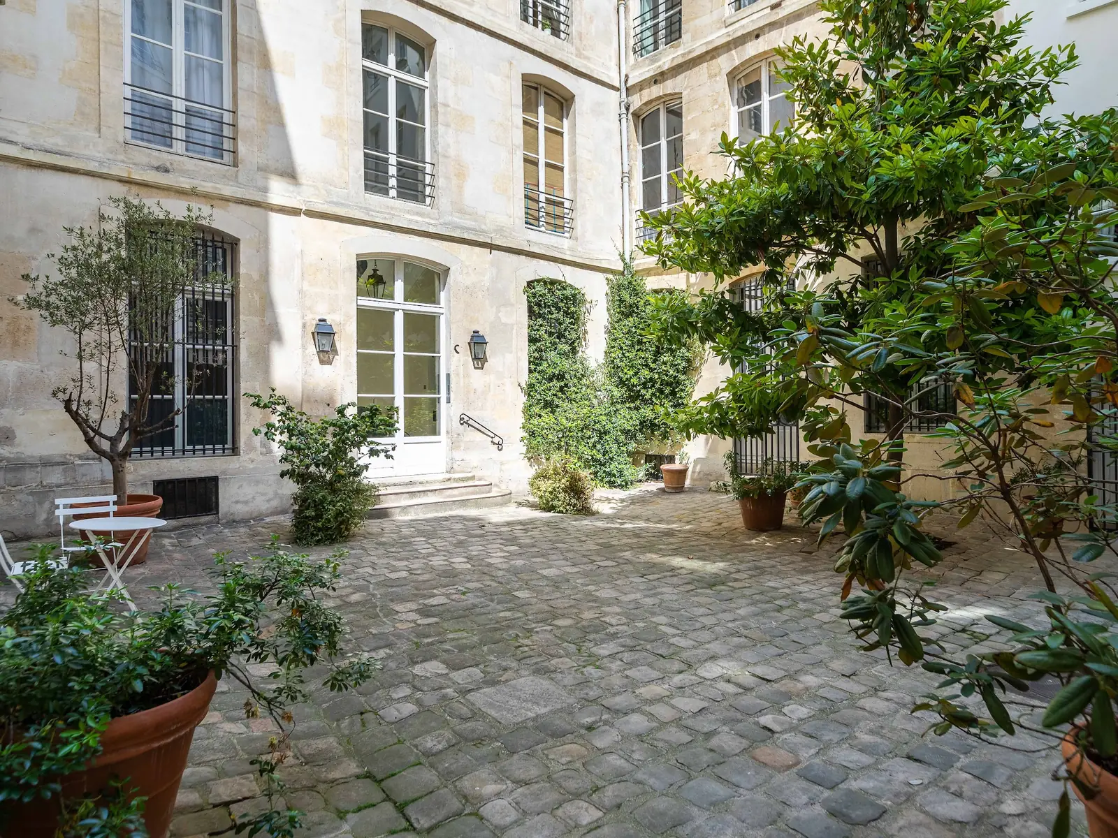 Cobbled, planted courtyard of a Paris building